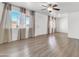 Bright living room featuring light wood floors, neutral walls, large windows and a ceiling fan at 1007 W 5Th St, Mesa, AZ 85201