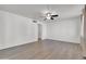 Spacious living room featuring light wood floors, neutral walls, and a ceiling fan at 1007 W 5Th St, Mesa, AZ 85201