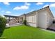 A backyard with an outdoor kitchen and covered patio with low maintenance artificial turf at 10145 E Cintron Dr, Mesa, AZ 85212
