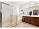 Bathroom featuring a bathtub, glass shower, double sink vanity and a window at 10145 E Cintron Dr, Mesa, AZ 85212