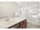 Bathroom featuring a double sink vanity, glass shower, and a large mirror at 10145 E Cintron Dr, Mesa, AZ 85212