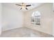 The bedroom has tiled flooring, ceiling fan, and arched window at 10145 E Cintron Dr, Mesa, AZ 85212