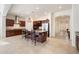 Bright, open kitchen with stainless steel appliances, large island with barstool seating, and dark wood cabinets at 10145 E Cintron Dr, Mesa, AZ 85212