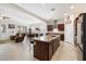 Spacious kitchen with granite counters, stainless steel appliances, and an island with seating at 10145 E Cintron Dr, Mesa, AZ 85212