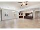 Bright, open-concept living room and kitchen featuring tile flooring and large windows at 10145 E Cintron Dr, Mesa, AZ 85212