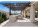 Spacious outdoor kitchen and a pergola, ideal for entertaining and dining al fresco at 10145 E Cintron Dr, Mesa, AZ 85212