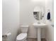 Clean and simple powder room with a pedestal sink and a modern toilet at 10145 E Cintron Dr, Mesa, AZ 85212