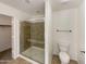 Bathroom featuring tiled shower with glass doors, toilet and fixtures at 10410 N Cave Creek Rd # 2119, Phoenix, AZ 85020