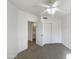 Clean bedroom featuring neutral carpeting, a closet with sliding doors and an ensuite bathroom at 10410 N Cave Creek Rd # 2119, Phoenix, AZ 85020