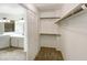 Spacious walk-in closet leading to ensuite bathroom with double vanity at 10410 N Cave Creek Rd # 2119, Phoenix, AZ 85020