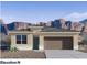 New construction home with desert landscaping, neutral colored stucco, and stone accents at 10619 W Sonrisas St, Tolleson, AZ 85353