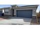 View of home's exterior showing concrete driveway and two-car garage door at 10619 W Sonrisas St, Tolleson, AZ 85353