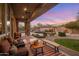Backyard with covered patio, desert landscaping, pool, and lounge seating at 10886 E Ludlow Dr, Scottsdale, AZ 85255