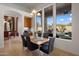 Bright dining area with large windows providing views of the manicured backyard at 10886 E Ludlow Dr, Scottsdale, AZ 85255