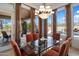 Bright dining room with pool view and glass table and seating for six at 10886 E Ludlow Dr, Scottsdale, AZ 85255