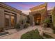 Stunning front entrance features a stone path, beautiful flowers, and elegant architecture at 10886 E Ludlow Dr, Scottsdale, AZ 85255