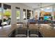 Open concept kitchen features stone countertops, with an inviting view of the living room at 10886 E Ludlow Dr, Scottsdale, AZ 85255