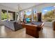Expansive living room featuring a pool table, fireplace and large windows with views of the desert landscape at 10886 E Ludlow Dr, Scottsdale, AZ 85255