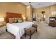 Spacious main bedroom with a fireplace and entry to the primary bathroom and walk in closet at 10886 E Ludlow Dr, Scottsdale, AZ 85255