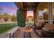 Covered outdoor seating area has comfortable furnishings and a stunning view of the surrounding landscape at 10886 E Ludlow Dr, Scottsdale, AZ 85255