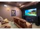 Comfortable theater room with reclining seats, large screen, and a movie poster at 10886 E Ludlow Dr, Scottsdale, AZ 85255