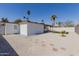 Charming backyard featuring gravel, stepping stones, and a small patch of green grass with a palm tree at 12207 N Escobar Way, Phoenix, AZ 85022