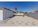 Backyard featuring gravel, stepping stones, a patch of grass, and a view of palm trees at 12207 N Escobar Way, Phoenix, AZ 85022