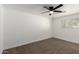Bright bedroom featuring neutral carpet, a ceiling fan, and a window providing natural light at 12207 N Escobar Way, Phoenix, AZ 85022