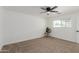 Neutral bedroom with ceiling fan, cozy carpet, and window views of the desert landscape at 12207 N Escobar Way, Phoenix, AZ 85022