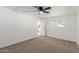 Bright bedroom featuring neutral carpet, a ceiling fan, and a window providing natural light at 12207 N Escobar Way, Phoenix, AZ 85022