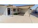 Cozy carport with fresh green lawn and a modern front door, perfect for welcoming guests at 12207 N Escobar Way, Phoenix, AZ 85022