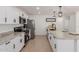 Modern kitchen features stainless steel appliances, white cabinets, and a large island for preparing food at 12207 N Escobar Way, Phoenix, AZ 85022