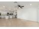 Bright living room with open floor plan, tile floors, and modern kitchen with island seating at 12207 N Escobar Way, Phoenix, AZ 85022