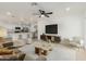 Open-concept living room flows into kitchen with breakfast bar, featuring tile flooring and stylish decor at 12207 N Escobar Way, Phoenix, AZ 85022