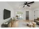 Comfortable living room featuring modern decor, a ceiling fan, and easy access to backyard patio at 12207 N Escobar Way, Phoenix, AZ 85022