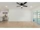 This living room features tile flooring, recessed lighting, and a sliding glass door for access to the outdoor space at 12207 N Escobar Way, Phoenix, AZ 85022