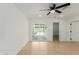 Bright living room with neutral paint, tiled floors, ceiling fan, and access to the backyard through sliding doors at 12207 N Escobar Way, Phoenix, AZ 85022