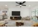 Inviting living room with a ceiling fan, modern decor, and sliding glass doors to outdoor patio at 12207 N Escobar Way, Phoenix, AZ 85022