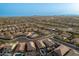 A high, aerial view of a new, expansive desert community nestled among mountain ranges and hills at 12924 W Caraveo Pl, Peoria, AZ 85383