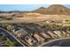 Aerial view of homes in a desert community nestled near mountains and an aqueduct at 12924 W Caraveo Pl, Peoria, AZ 85383
