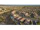 Aerial view showcasing a well-planned desert community, including a roundabout and mountain scenery at 12924 W Caraveo Pl, Peoria, AZ 85383