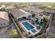 Aerial view of a backyard with a pool, spa, outdoor seating area, and manicured landscaping and artificial turf at 12924 W Caraveo Pl, Peoria, AZ 85383