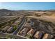 Birds-eye-view of an upscale community featuring desert landscape, nearby mountains, and open skies at 12924 W Caraveo Pl, Peoria, AZ 85383