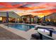 Beautiful backyard with a large pool, spa, water features, and comfortable lounge chairs for relaxation at 12924 W Caraveo Pl, Peoria, AZ 85383