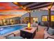 Charming backyard featuring a pool, fire pit, and seating, ideal for outdoor entertaining at 12924 W Caraveo Pl, Peoria, AZ 85383