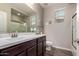 Bathroom with a walk-in shower, a large vanity, and decorative elements at 12924 W Caraveo Pl, Peoria, AZ 85383
