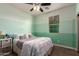 Cozy bedroom with two-tone paint, natural light, and comfortable furniture at 12924 W Caraveo Pl, Peoria, AZ 85383