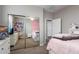 Bright bedroom features a large mirrored closet and soft, pink accents at 12924 W Caraveo Pl, Peoria, AZ 85383