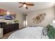 Well-lit bedroom with a decorative wall and large mounted television at 12924 W Caraveo Pl, Peoria, AZ 85383