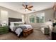 Comfortable bedroom featuring a ceiling fan, windows, and a decorative headboard at 12924 W Caraveo Pl, Peoria, AZ 85383